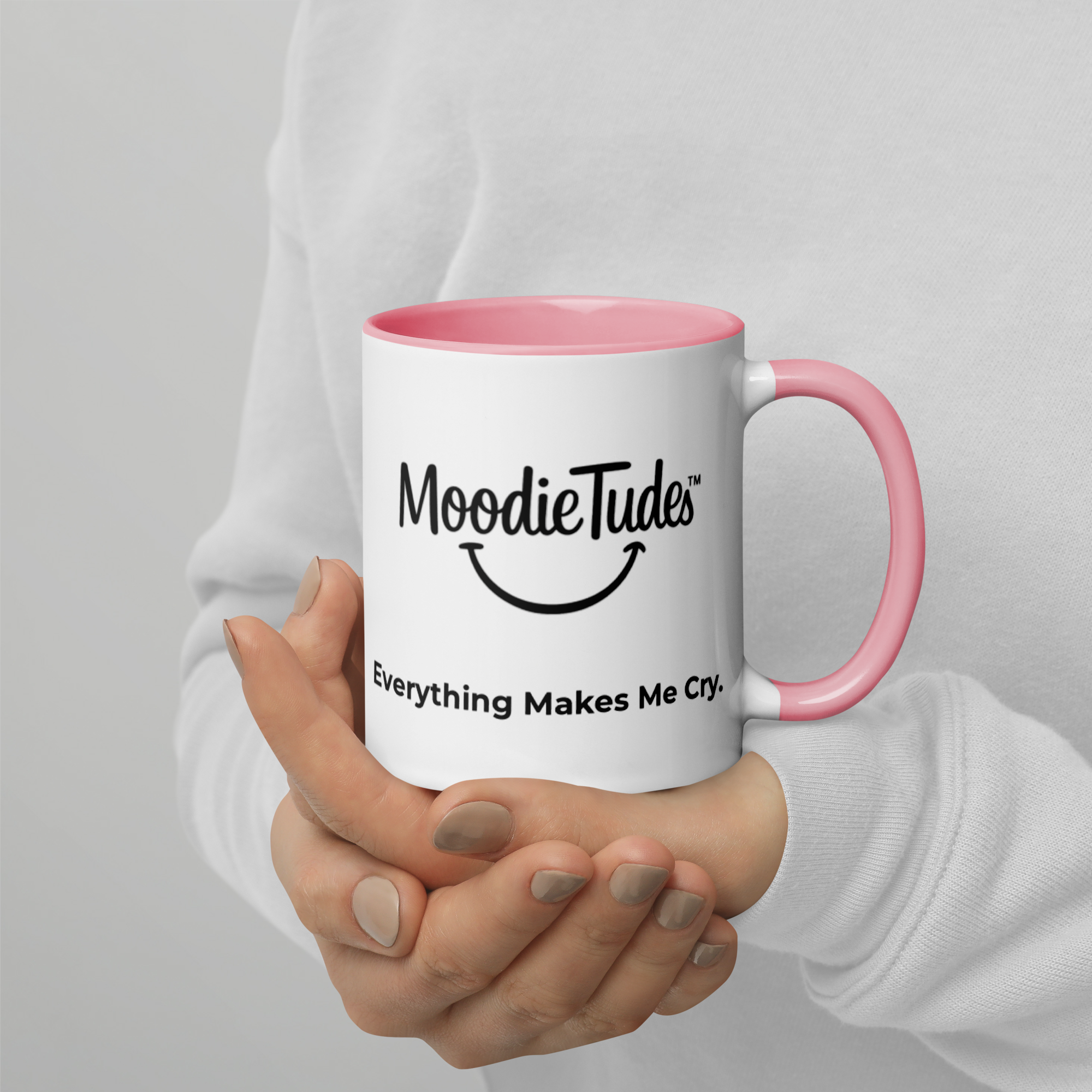 MoodieTudes™ Everything Makes Me Cry mug held in hand, logo side visible