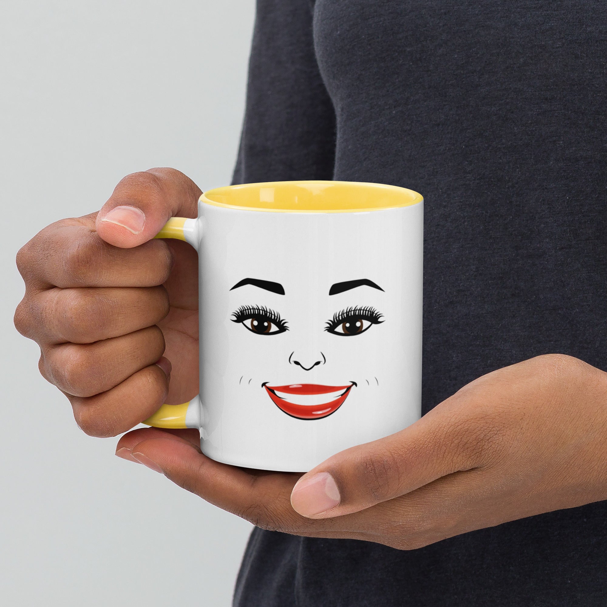 MoodieTudes™ Radiant mug held in hand, face design visible